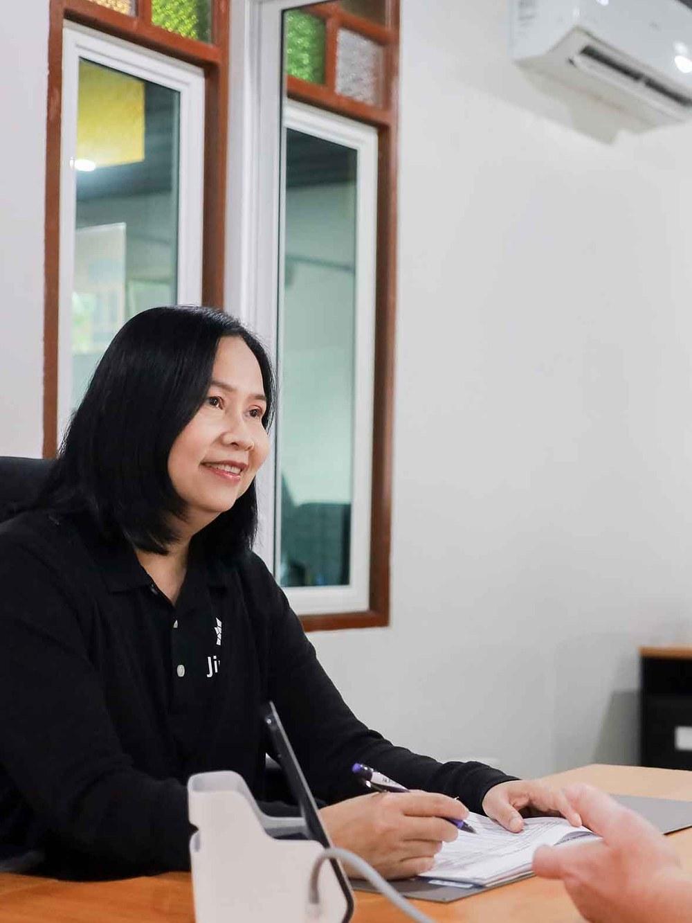 Jintara nurse reviewing paperwork at the on-site medical assessment desk