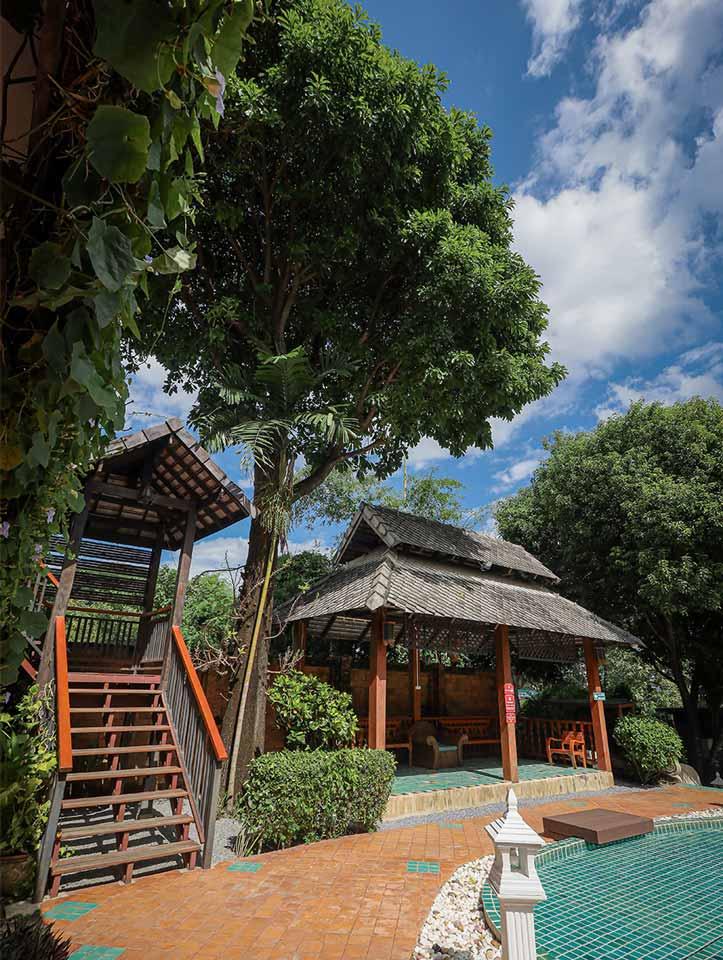 Poolside with Lanna sala and mature trees at Jintara Rehab centre in Chiang Mai