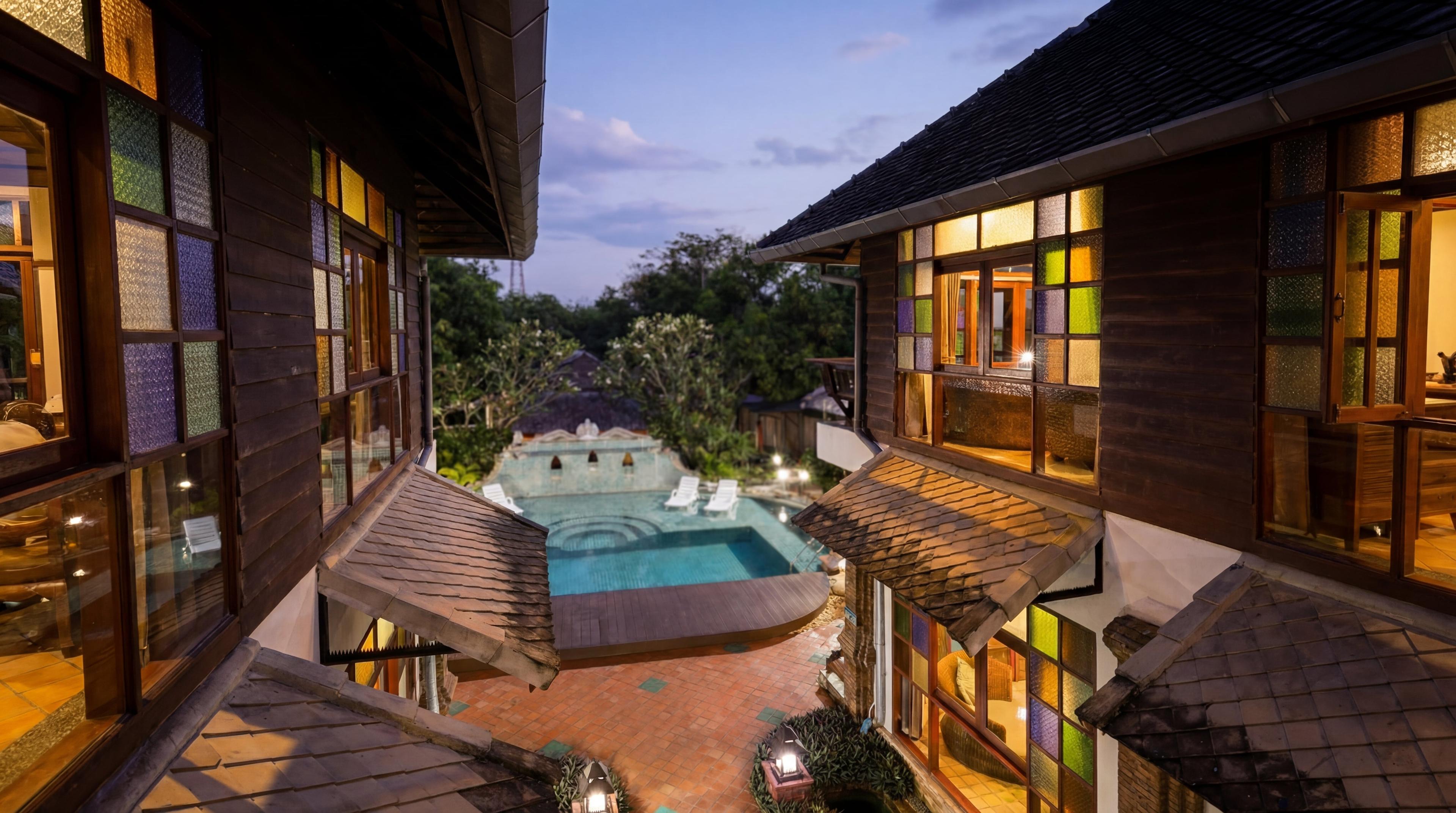 Jintara Rehab facility at twilight showing the pool and Lanna-style buildings in Chiang Mai